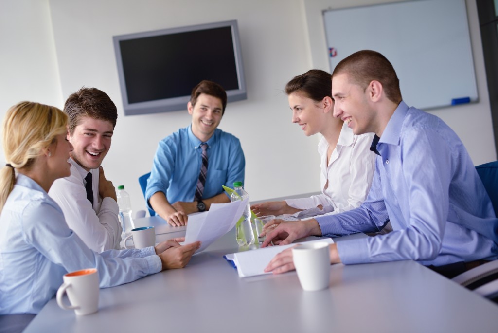 Group of happy young  business people in a meeting at office